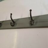 Wooden coat rack with cast iron hooks