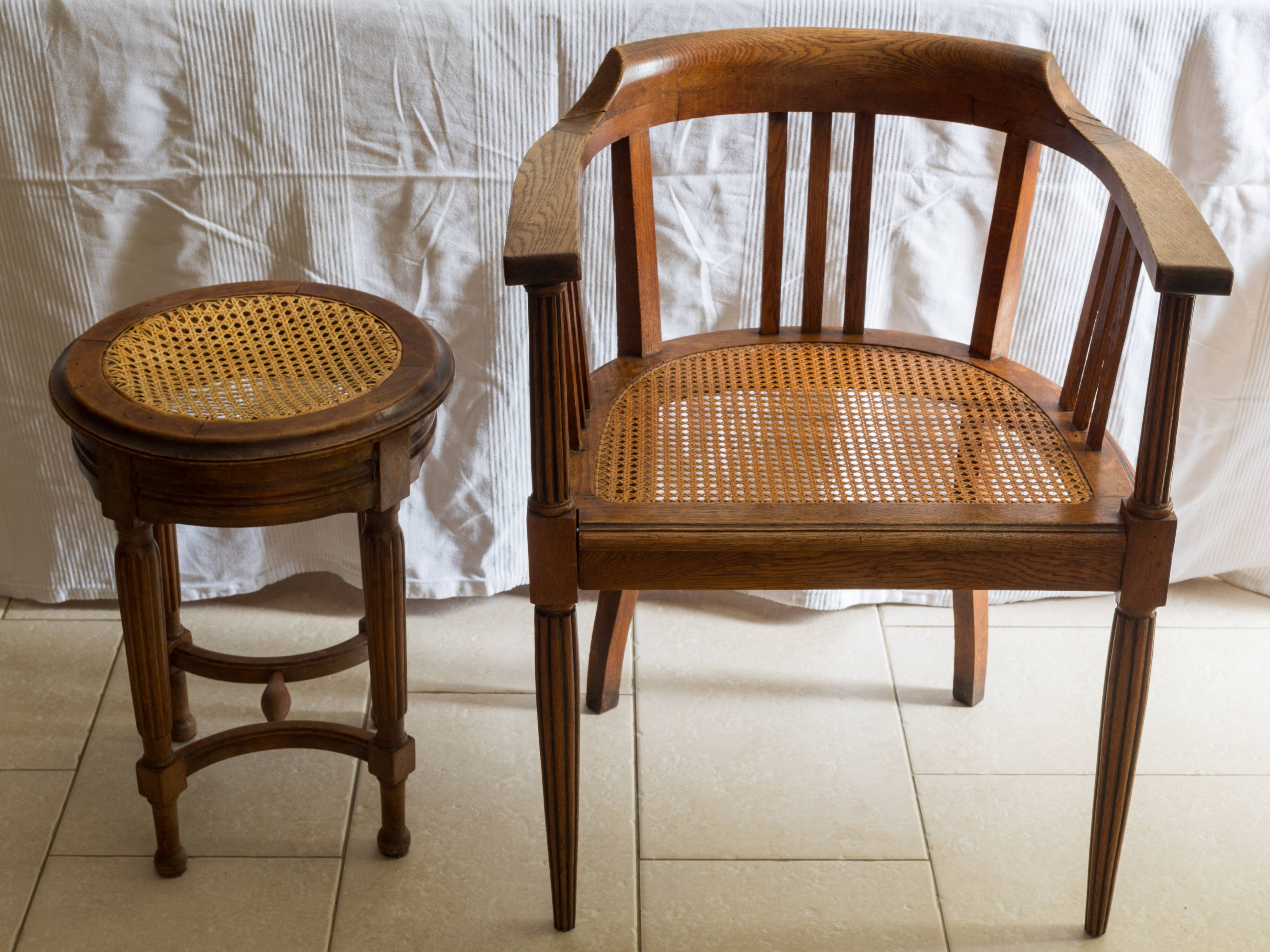 Antique armchair and stool with caned seat and fluted legs