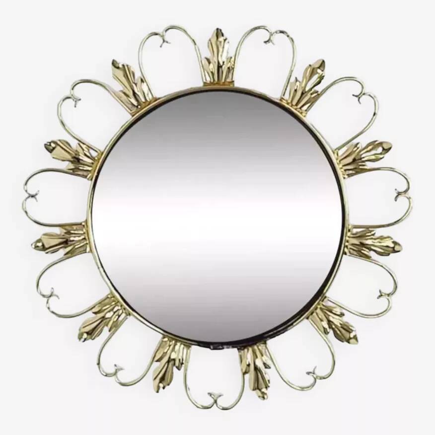 Round mirror on a brass frame with scrolls