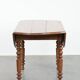 Antique English drop-leaf dining table made of walnut with elegant legs