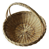 Round wicker basket with a rigid handle.