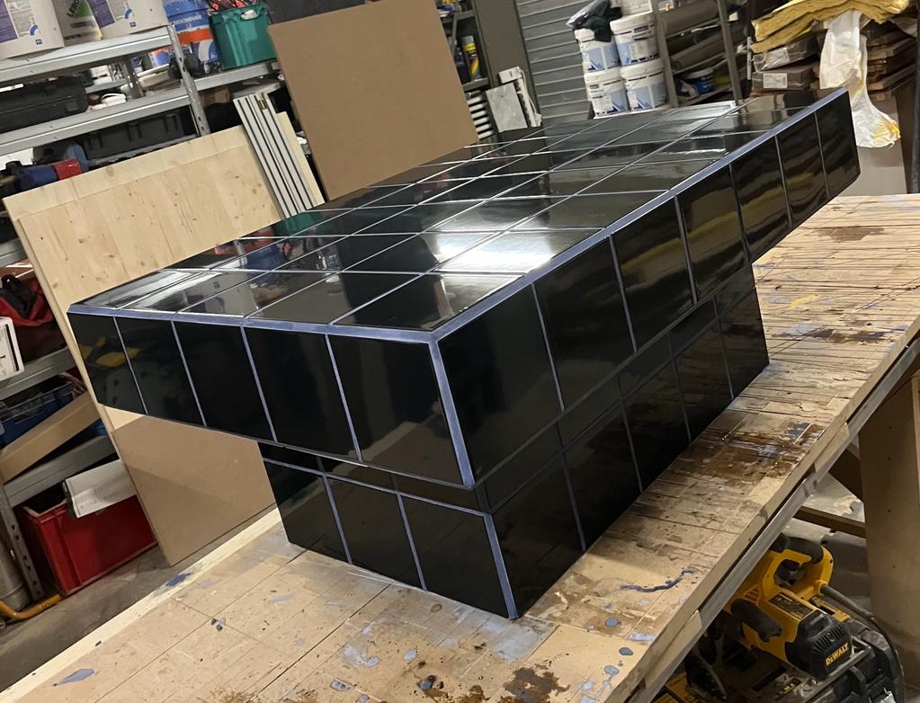 Black tiled coffee table and midnight blue grout