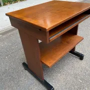 Small Scandinavian-style computer desk on wheels made of wood.