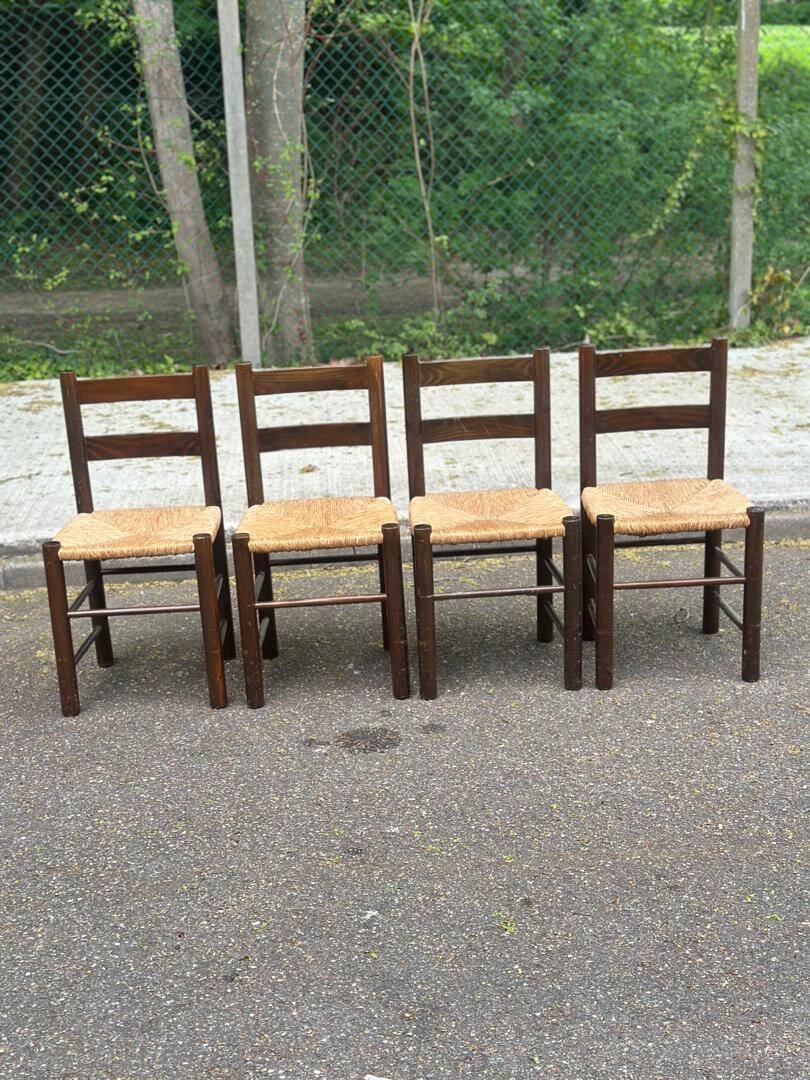 4 solid oak chairs in dark colour with elephant upholstery.
