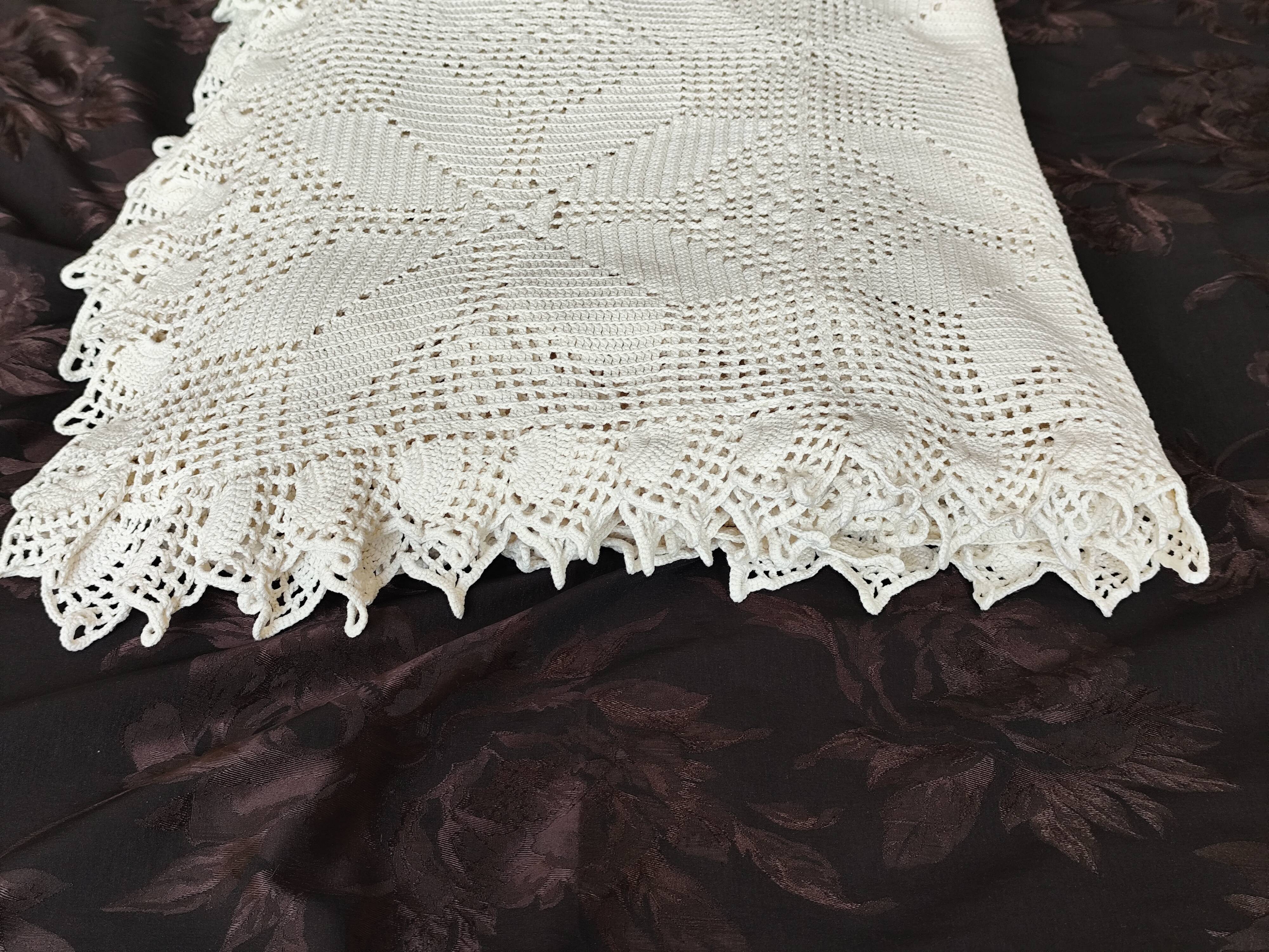 White cotton bedspread, crocheted sofa throw with star patterns