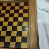 old wooden game board: small horses and checkers