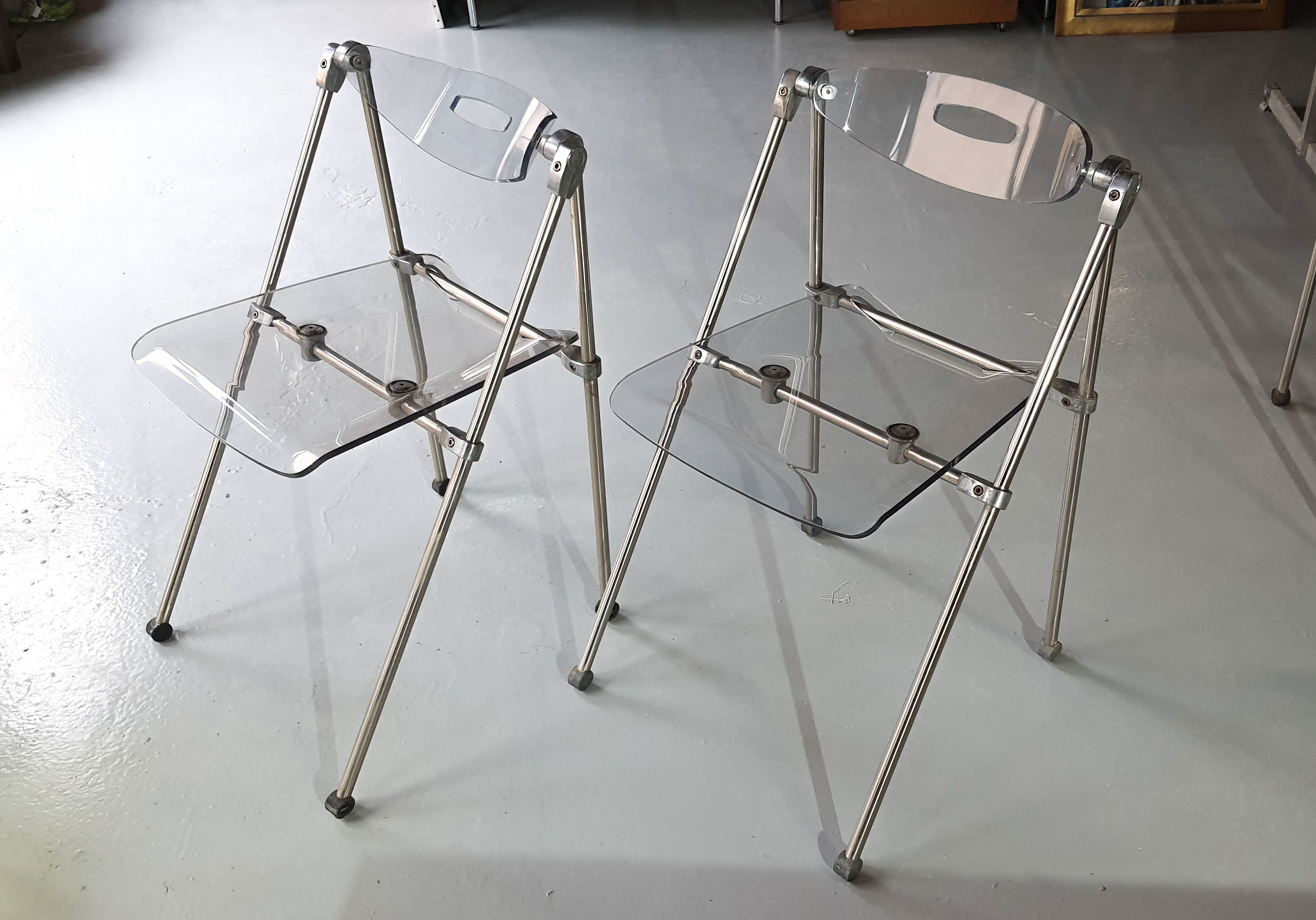 Pair of modern folding chairs in plexiglass