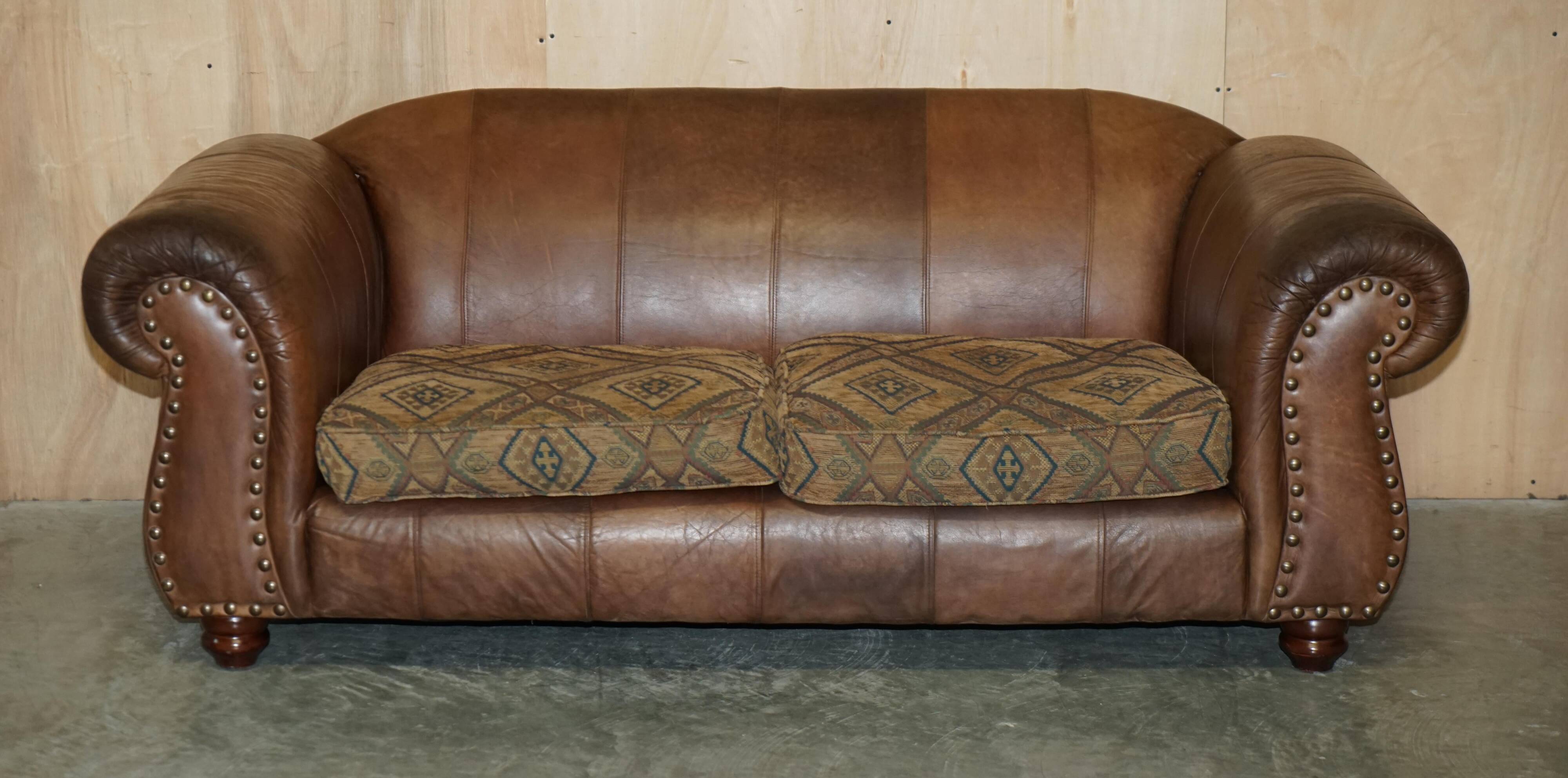 Vintage leather sofas by Thomas Lloyd with Kilim cushions.
