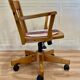 Solid wood swivel and reclining armchair.