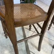 Pair of antique caned and wooden chairs from the 1900s.