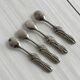 Antique small spoons with a metal bow design
