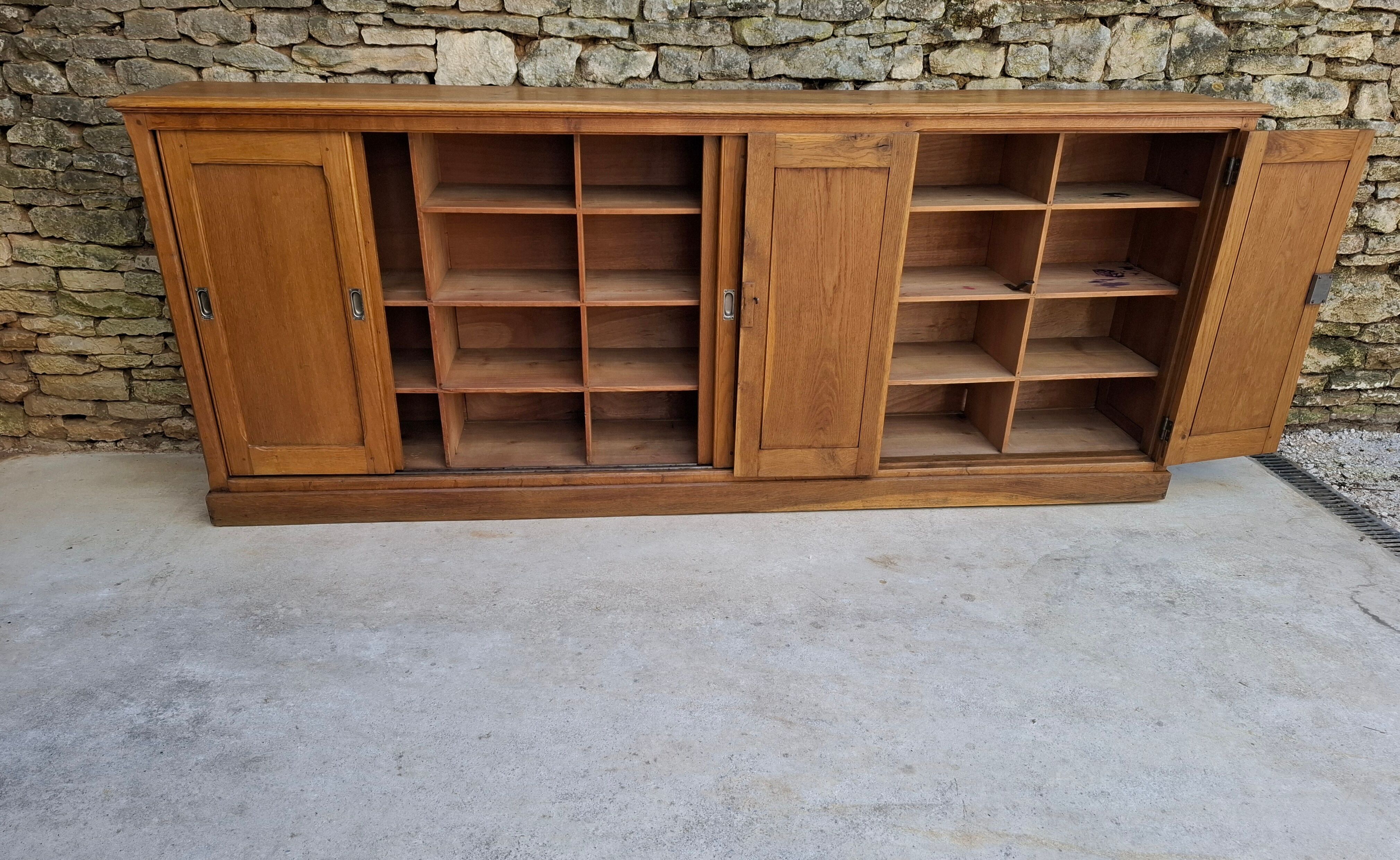 Oak workshop furniture with sliding doors.