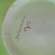 4 hand-decorated earthenware plates with vegetable and green leaf designs.