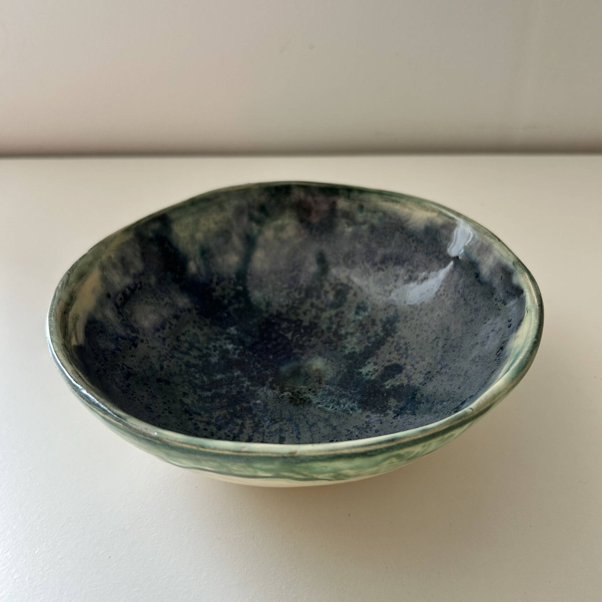 Green bowl signed with an eye