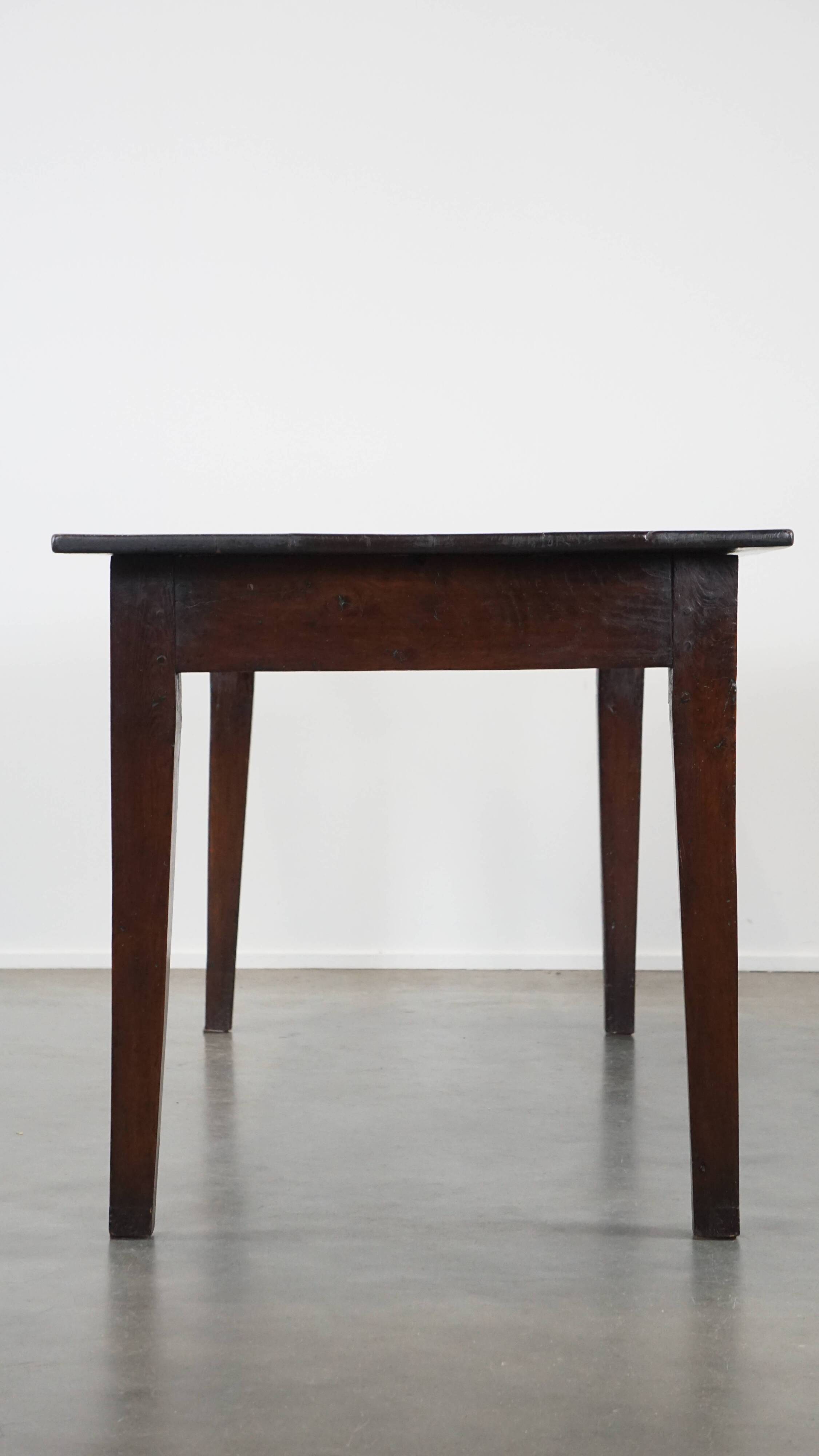 Antique French fruitwood dining table with 2 drawers and patina