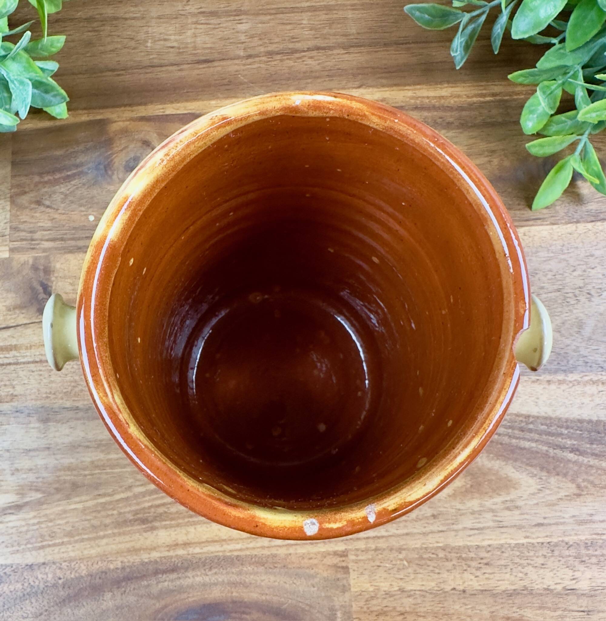 Antique ceramic pot with hand-painted floral decoration.