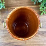 Antique ceramic pot with hand-painted floral decoration.