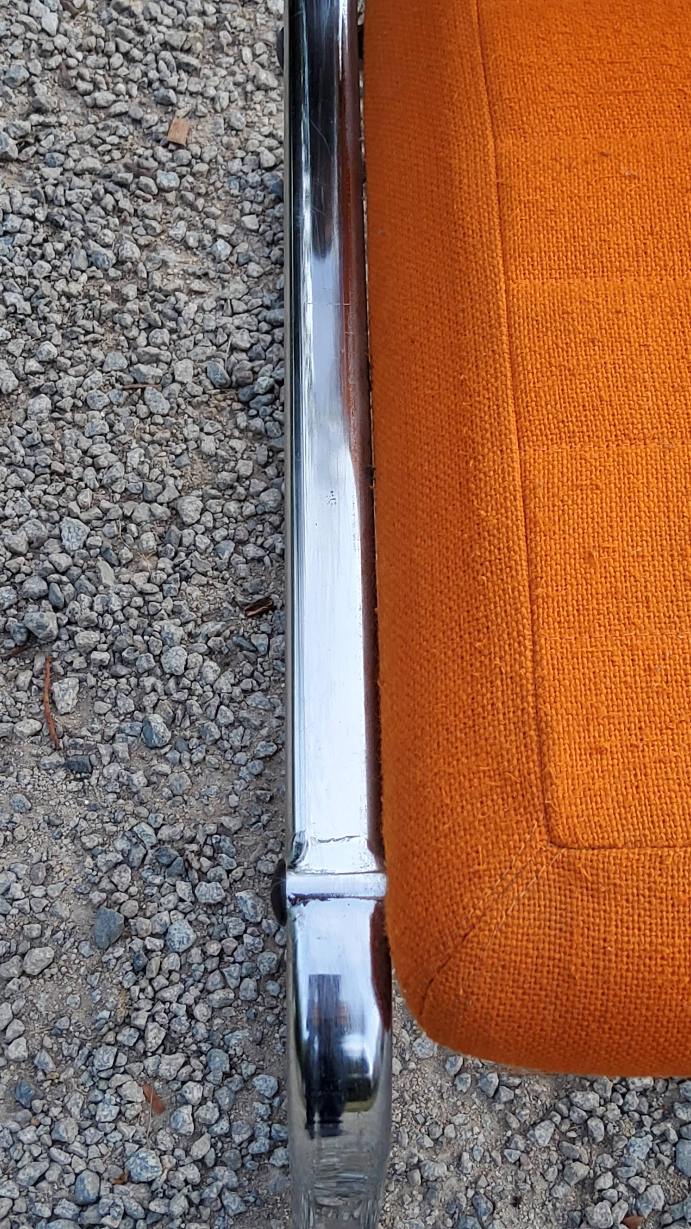 Pair of designer armchairs in orange fabrics and chrome tubes from the 70s