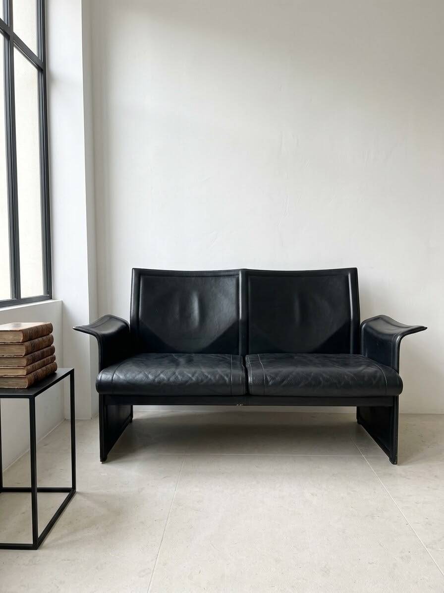 Small vintage black faux leather sofa
