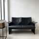 Small vintage black faux leather sofa