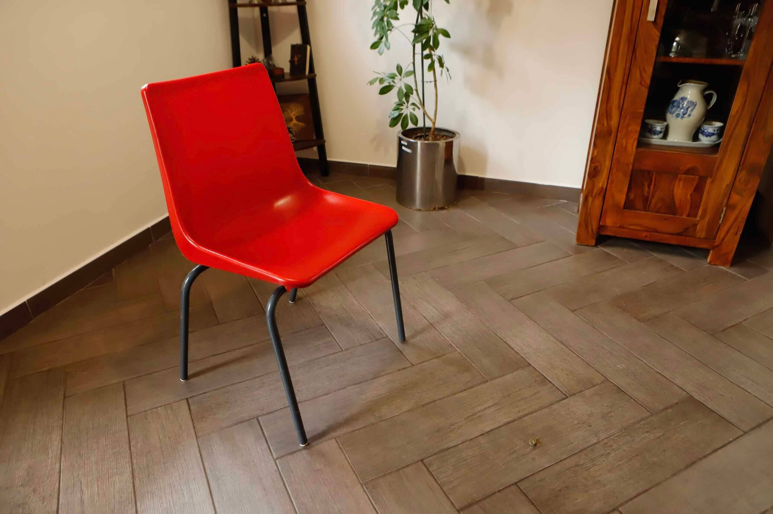 Pair of red plastic chairs with metal frame