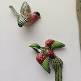 Two exotic birds in slip to hang