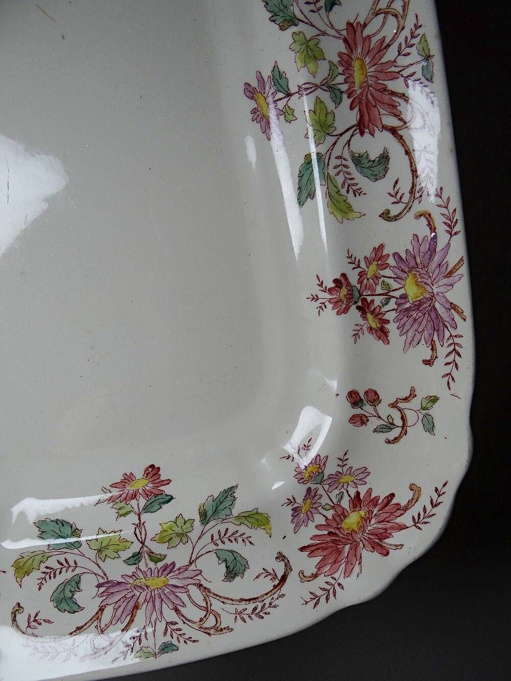 Antique Longchamp serving platter with polychrome daisies in ironstone.