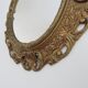 Golden baroque oval mirror, 60s-70s