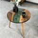 Round resin coffee table with a natural edge.