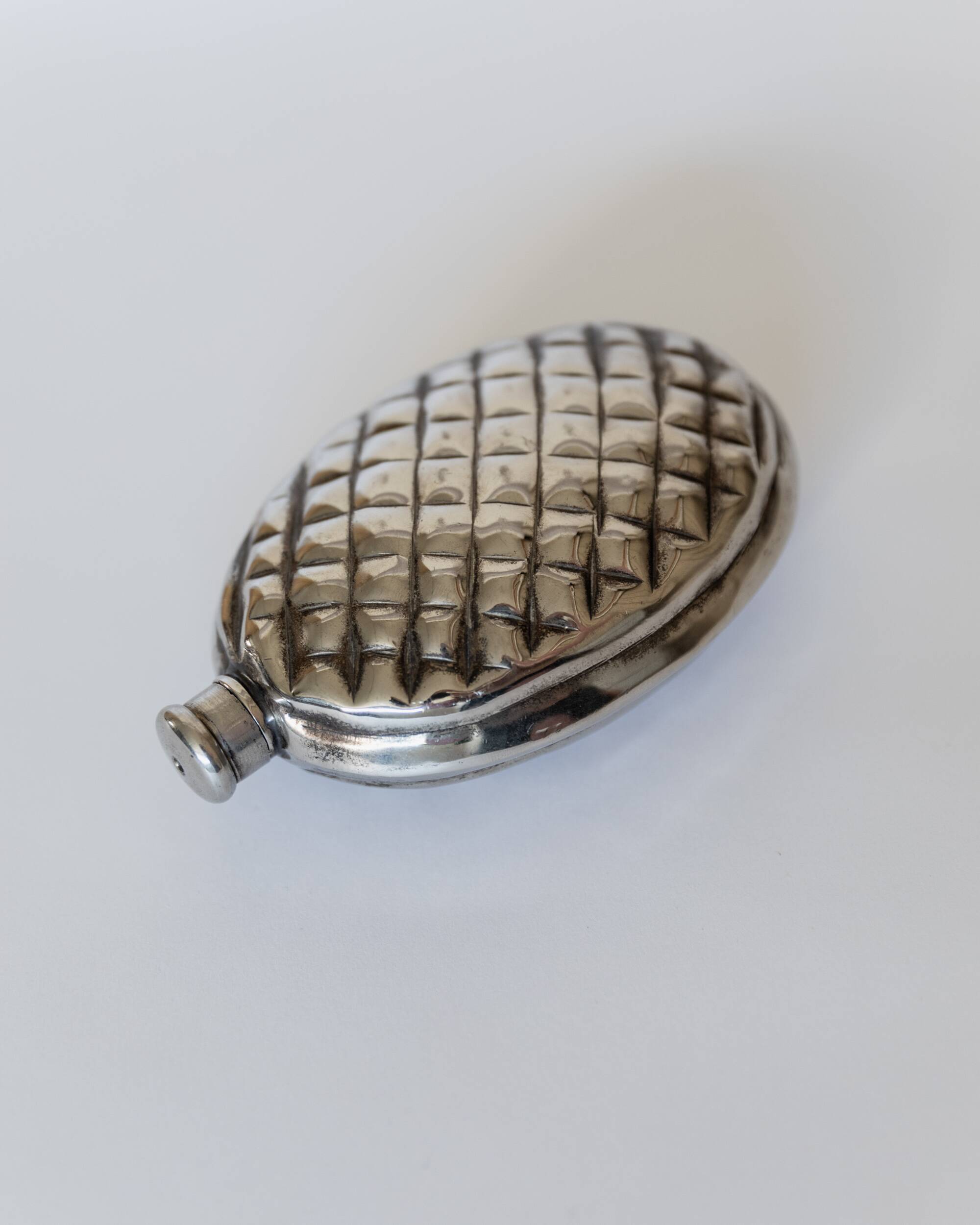 Vintage 1950s silver-plated flask in the shape of a pine cone.