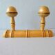 Coat rack with 2 wooden hooks imitating bamboo.