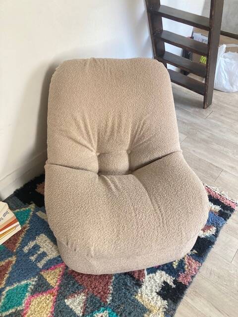 Vintage armchair reupholstered in boucle fabric.