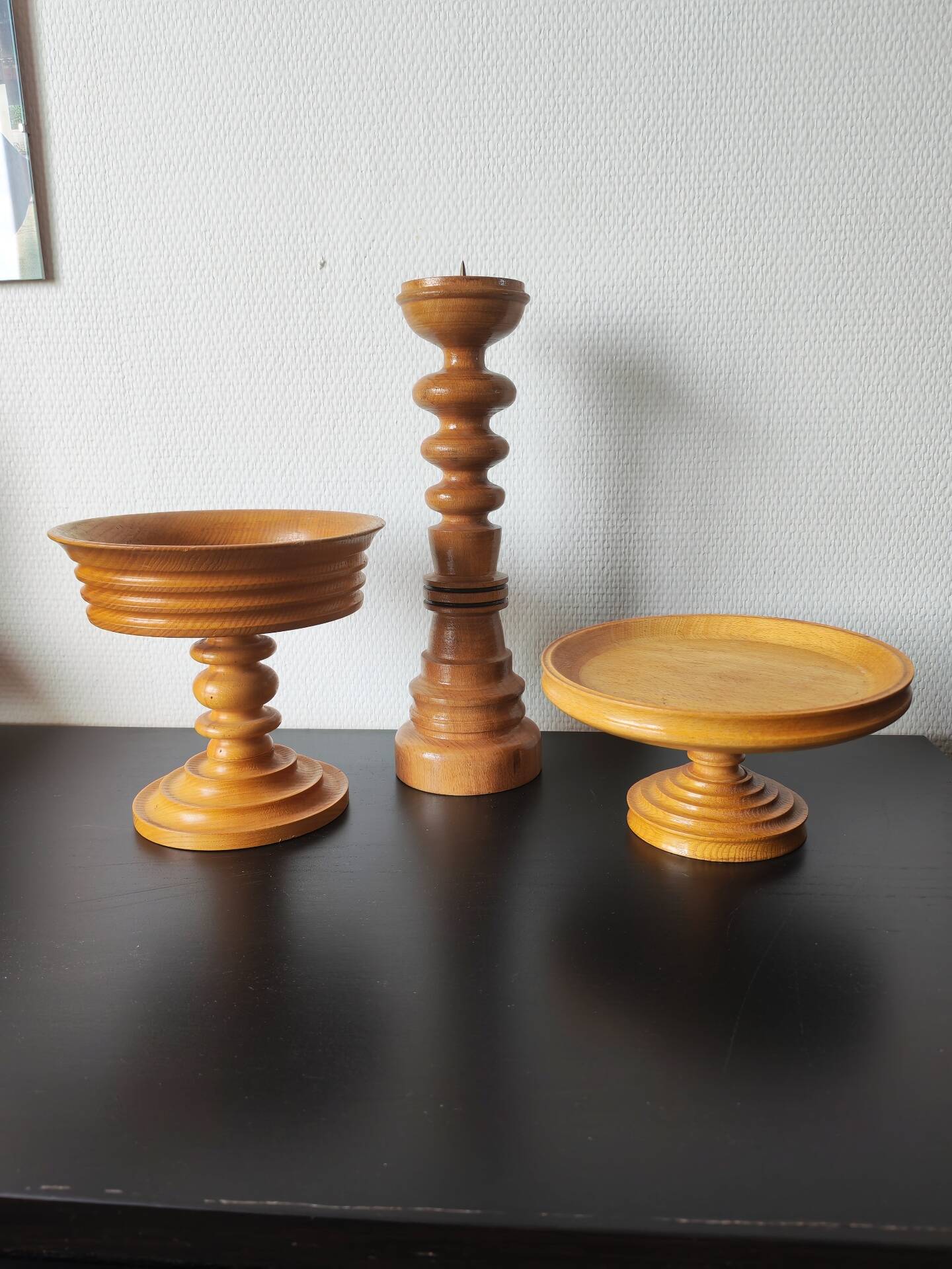 Vintage decor trio: candlestick and light wood bowls in Scandinavian style.