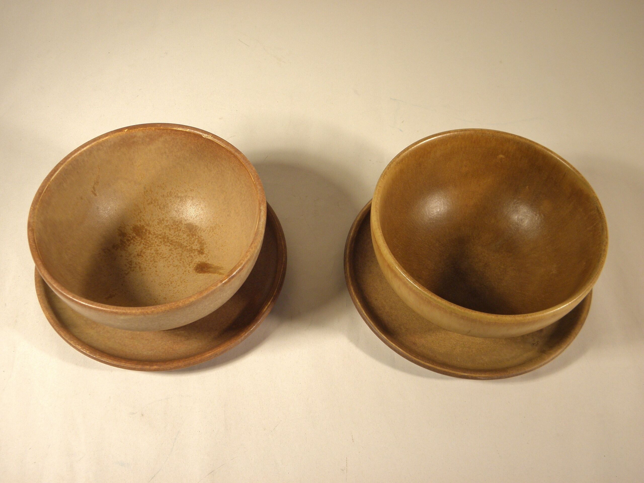 Two sandstone bowls and saucers