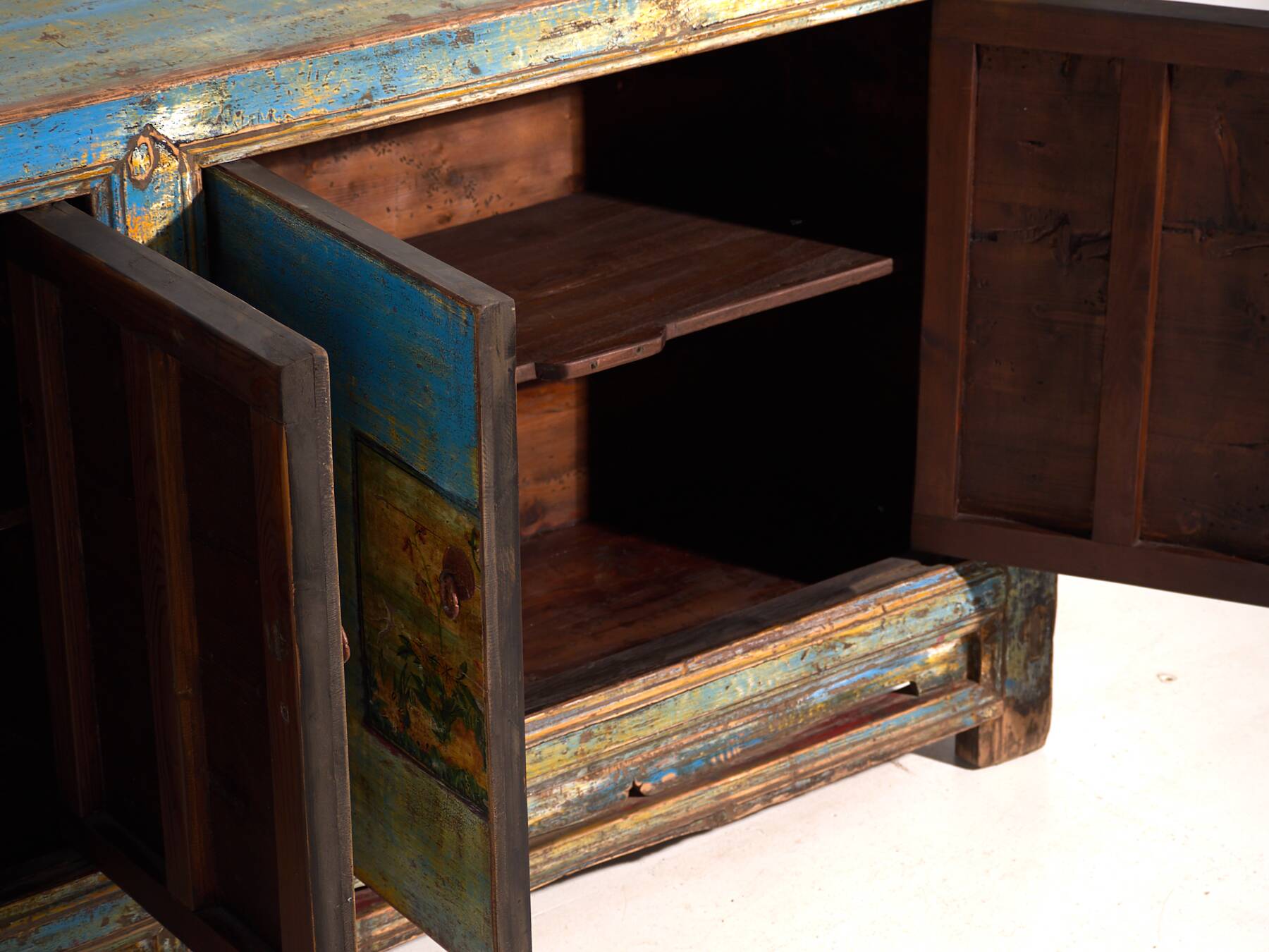 Old wooden entrance buffet in blue and yellow tones (circa 1920).