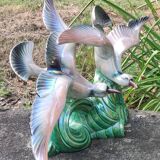 Old barbotine statue seagulls on the wave