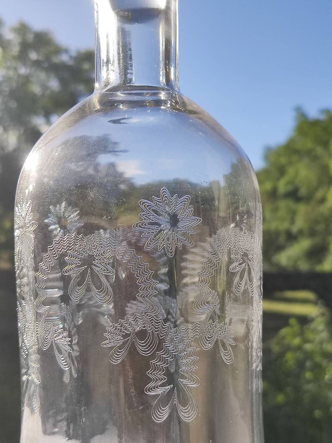 Two antique engraved glass bottles