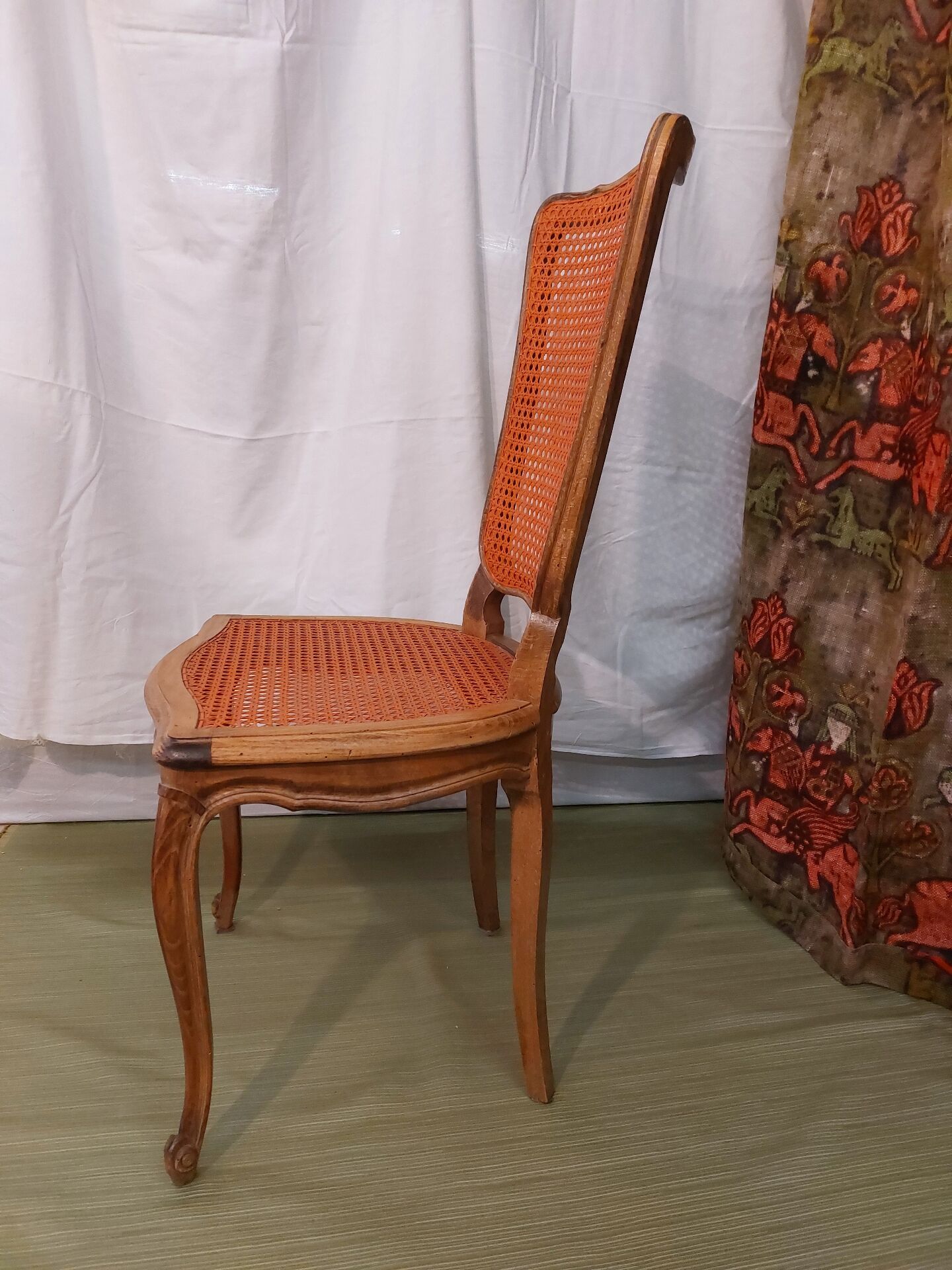 Caned chair in Louis XV style painted orange.