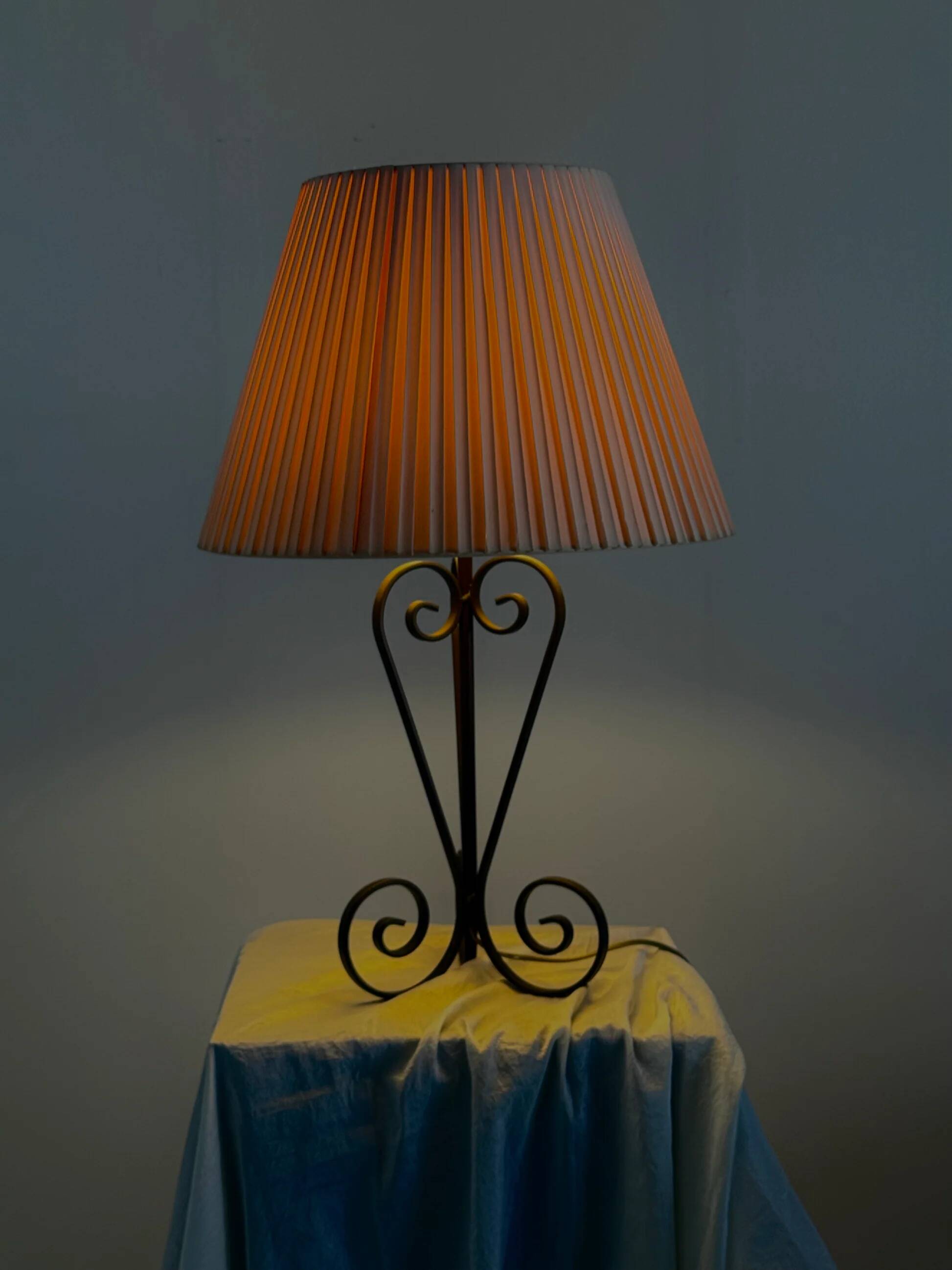 Vintage wrought iron table lamp in swirl shape with pleated shade