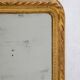 19th-century patinated mirror with a ribbon-style frame