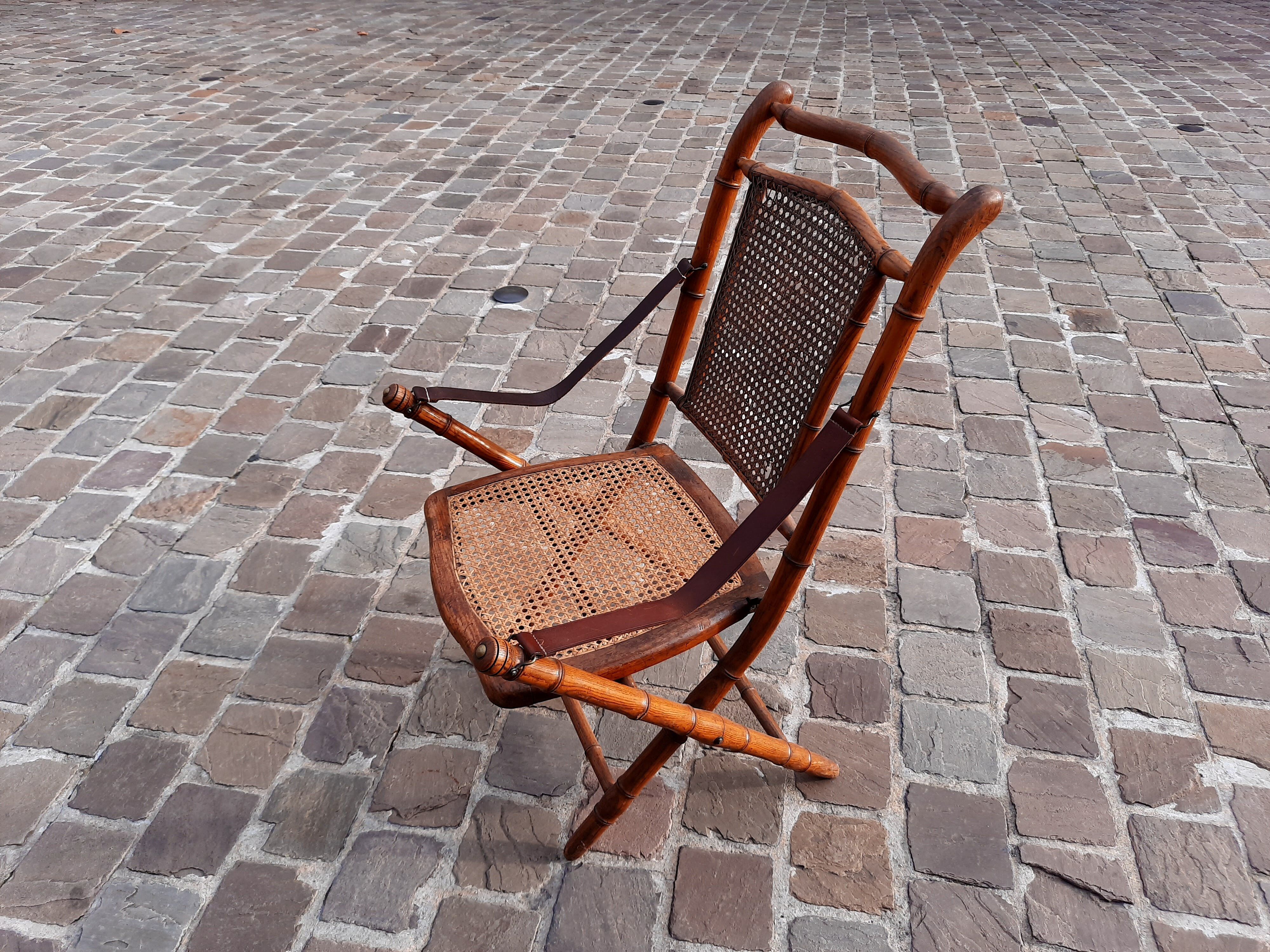 Bamboo folding chair and caning, leather and brass