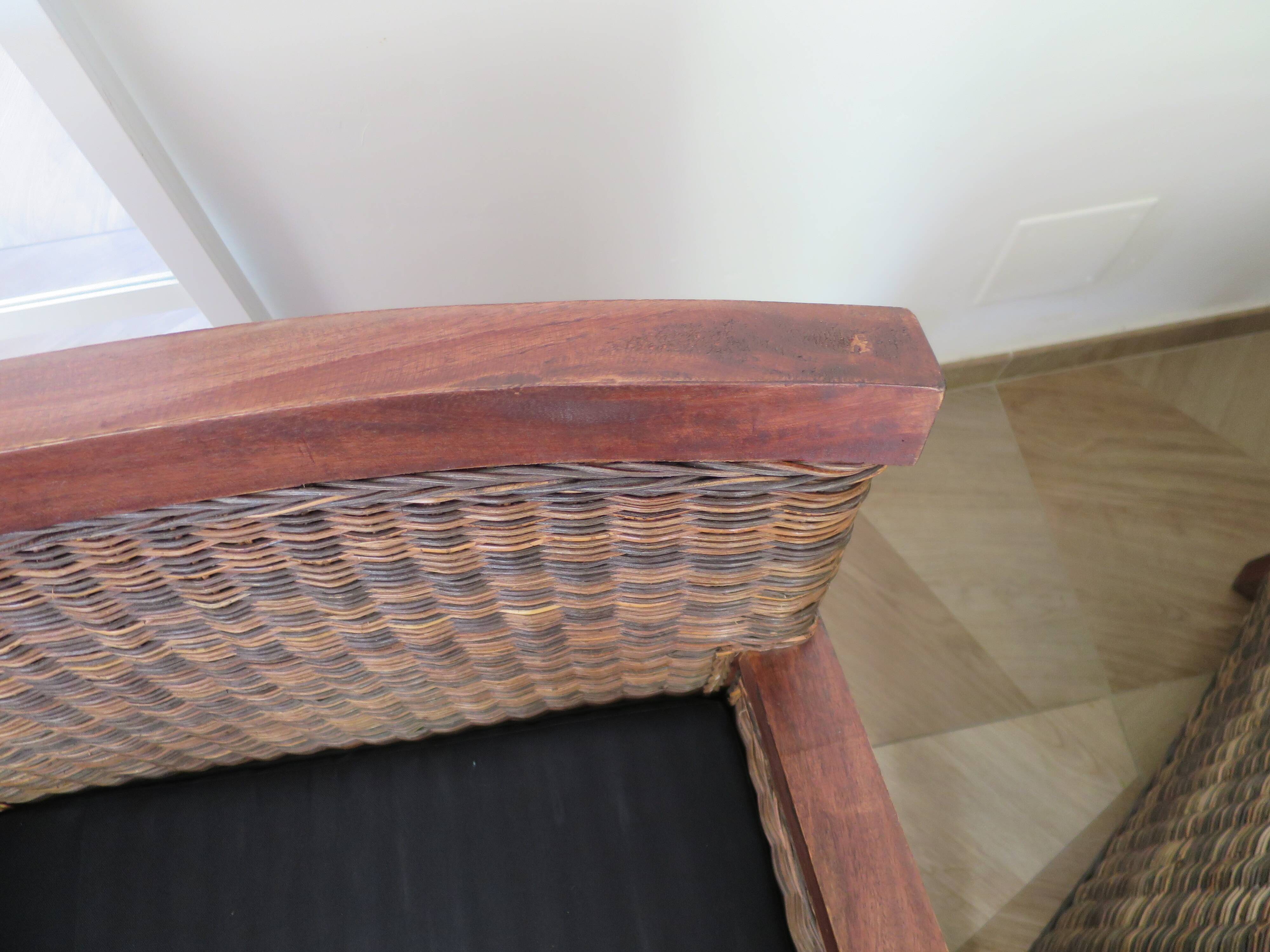 2 colonial-style armchairs in woven rattan and exotic wood