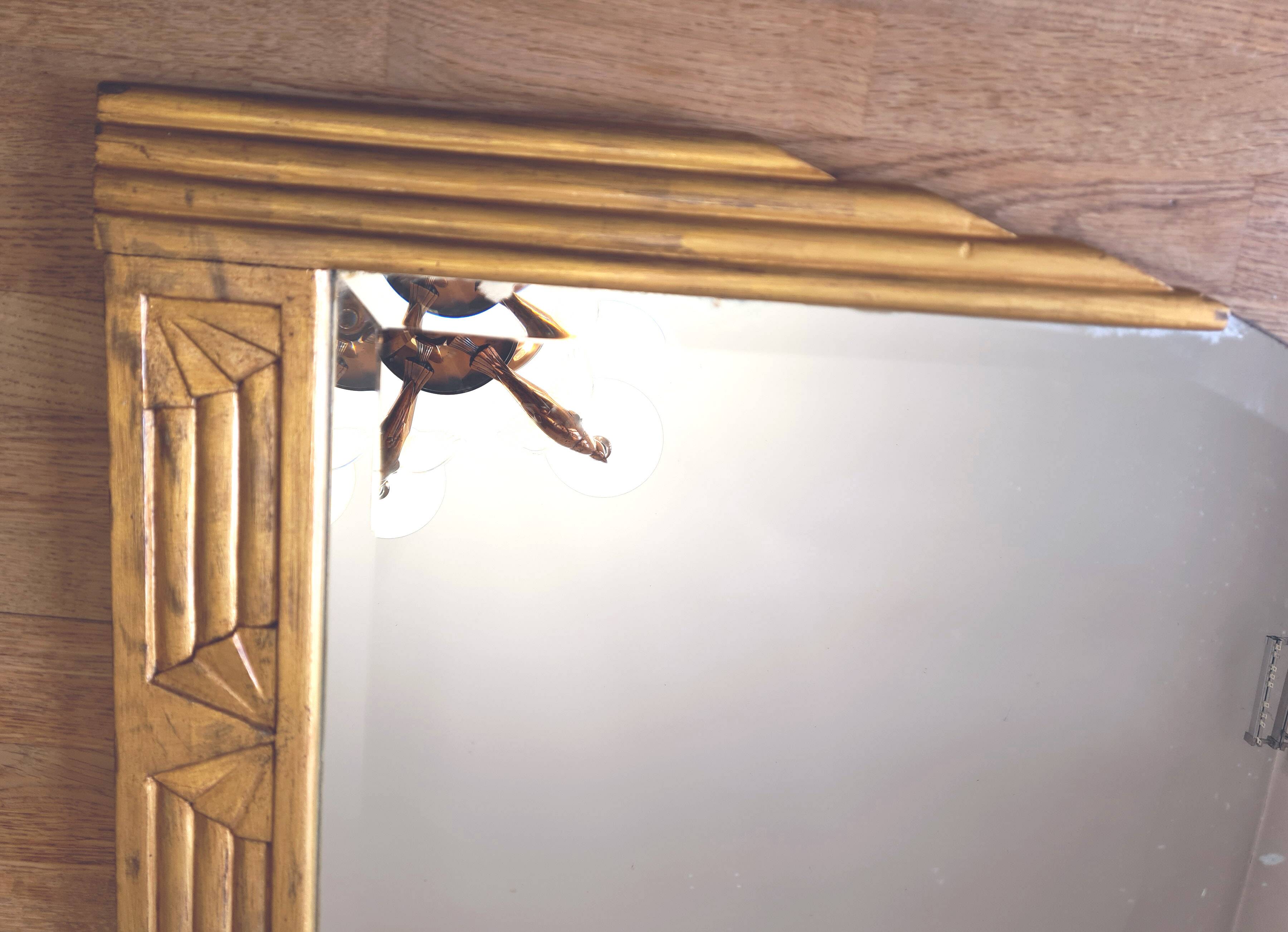 Antique Art Deco mercury mirror, in carved wood with gold leaf.