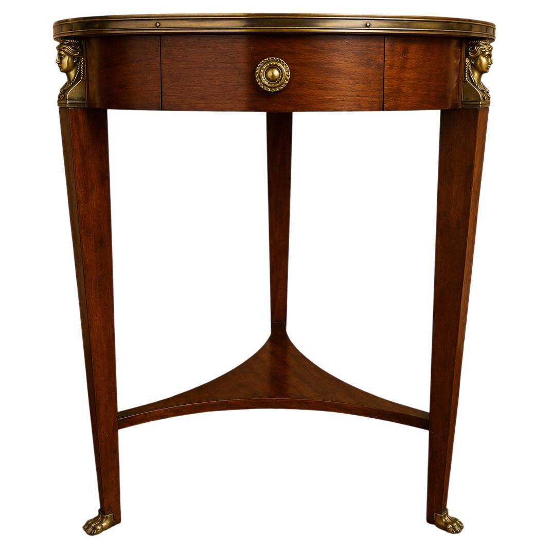 Empire guéridon table in mahogany with a black marble top and gilded bronze.