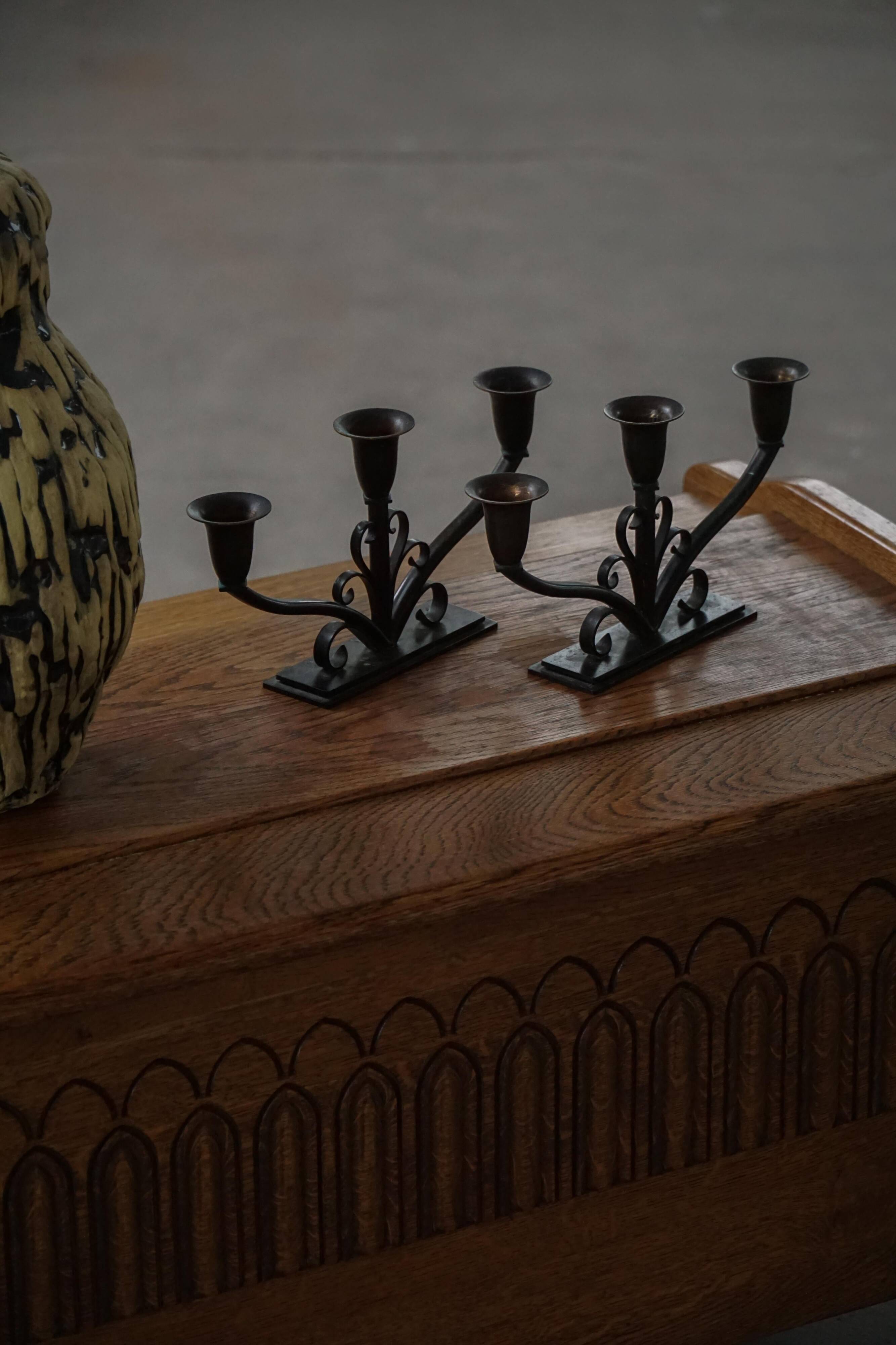 Early 20th century, pair of Danish Art Deco candlesticks in metal with three arms, 1930s.