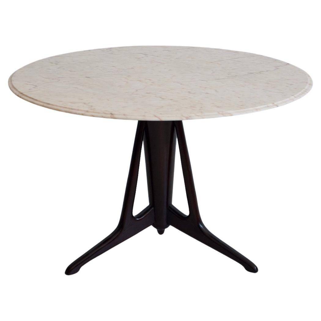 Mid-century modern round dining table in marble and ebony wood.