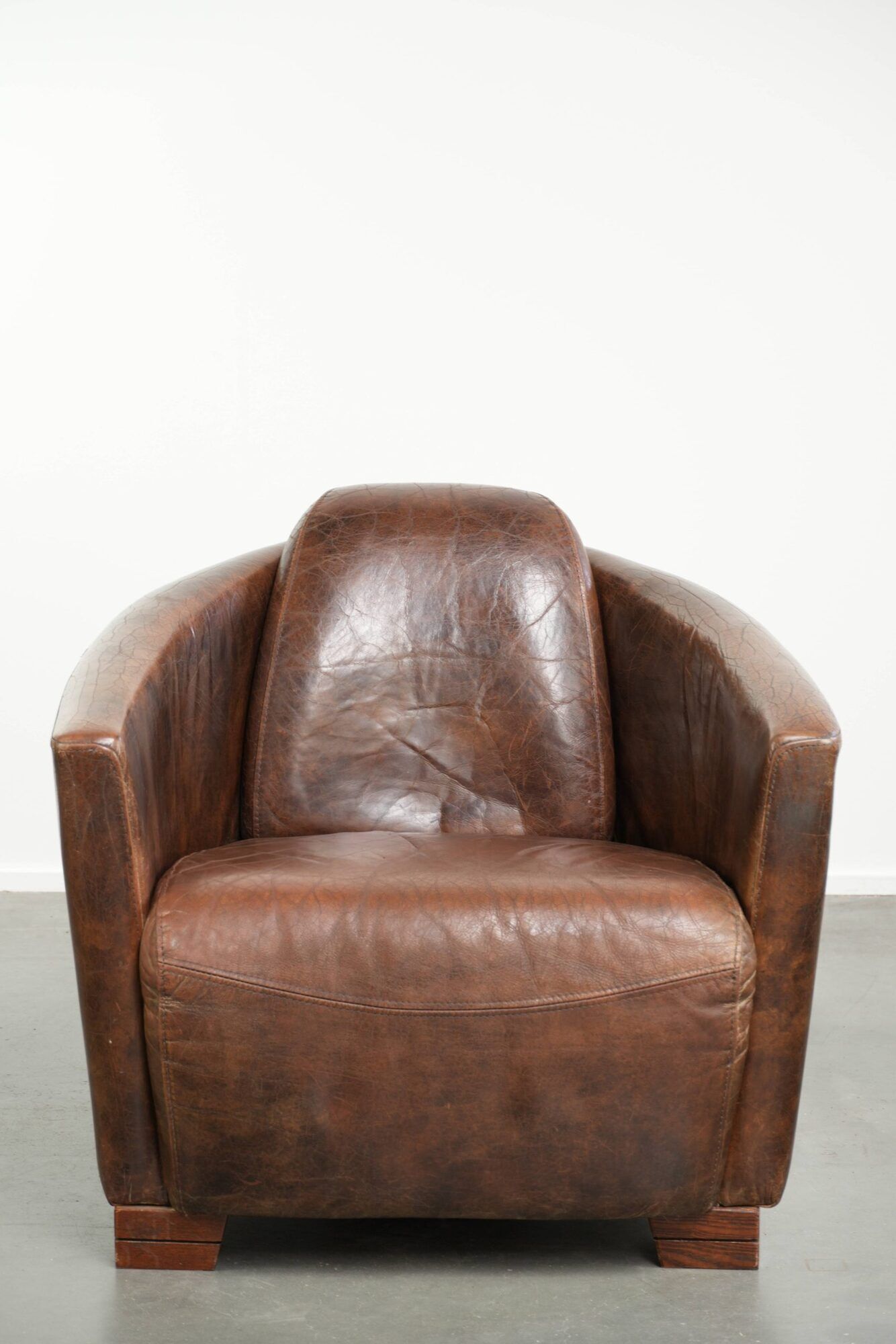 Cowhide armchair in Aviator design in a warm brown colour