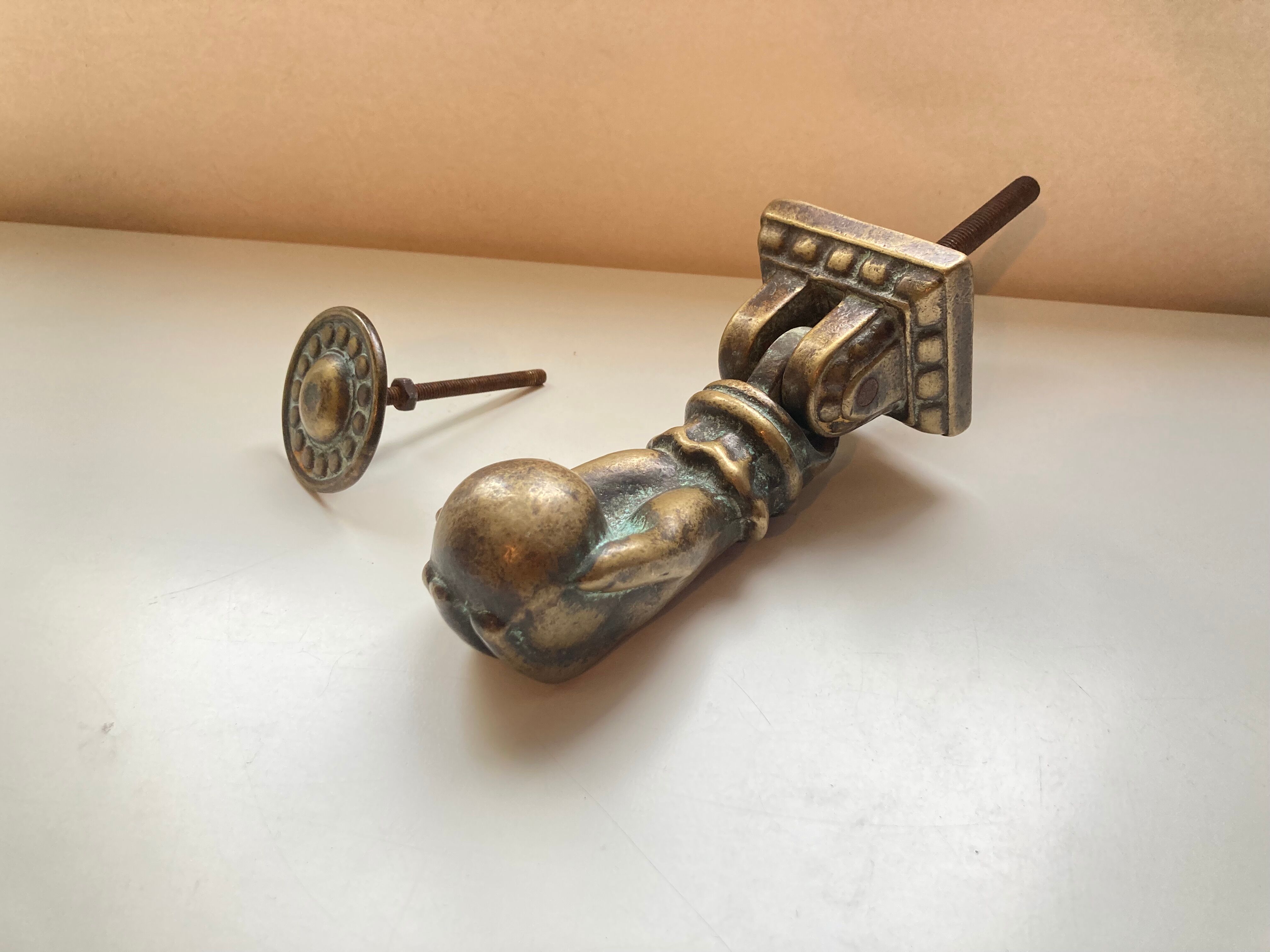 Antique bronze hand-shaped door knocker