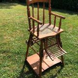 Old baby high chair in wood and canework