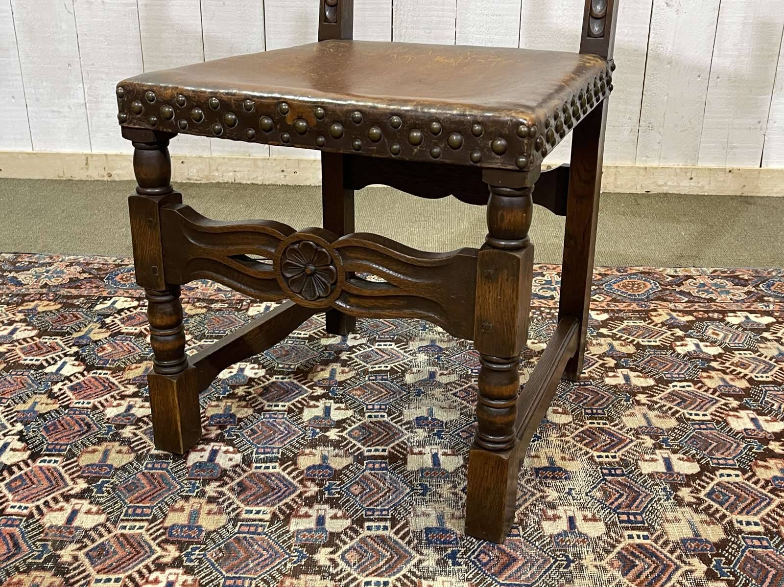 High-backed chair from the early 20th century in oak and leather